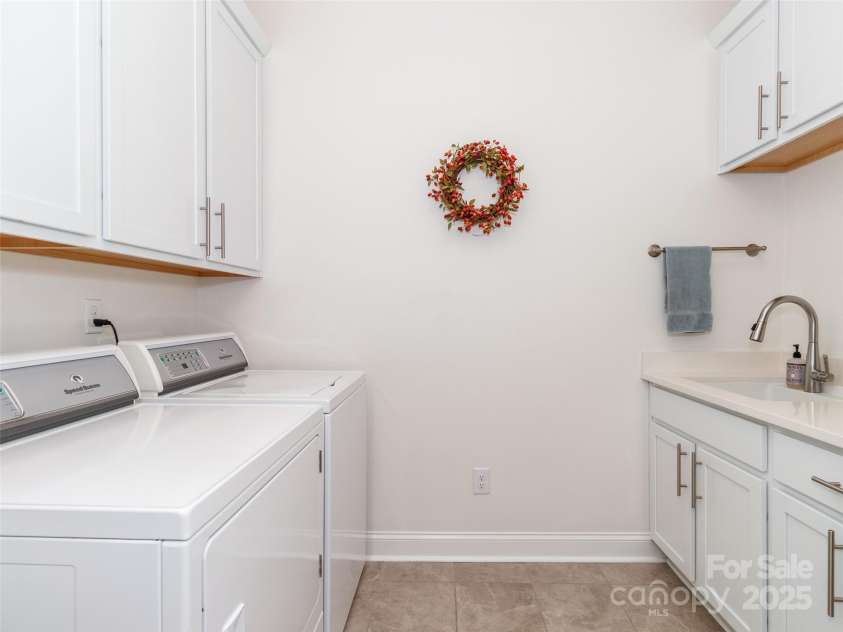 2342 Wesley Landing Road, Waxhaw, NC 28173.  MLS# CAR4238827, YatesRealty ID 11736. Laundry room with sink and cabinets