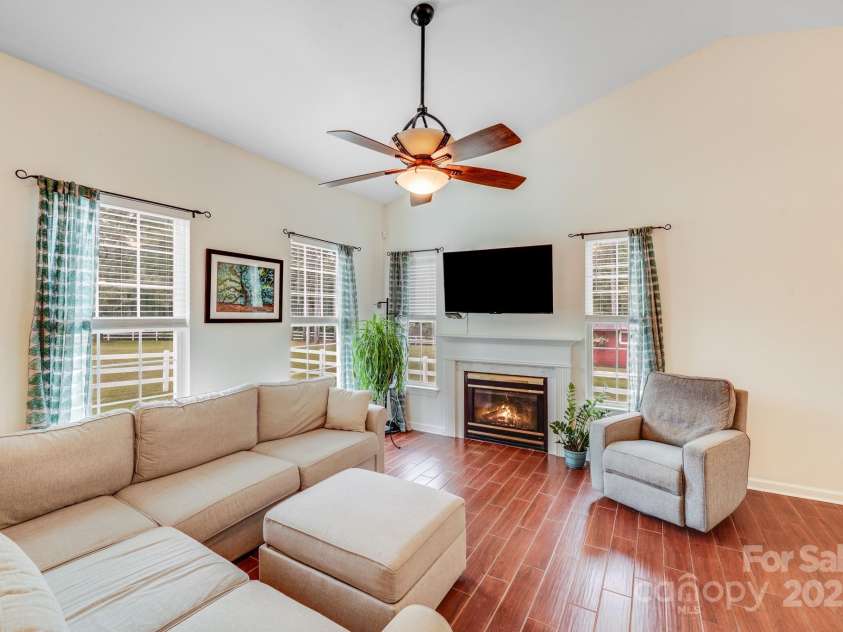 6910 Birdsong Lane, Waxhaw, NC 28173.  MLS# CAR4253788, YatesRealty ID 11745. Great room with gas logs, ceiling fan, custom tile, and vaulted ceiling