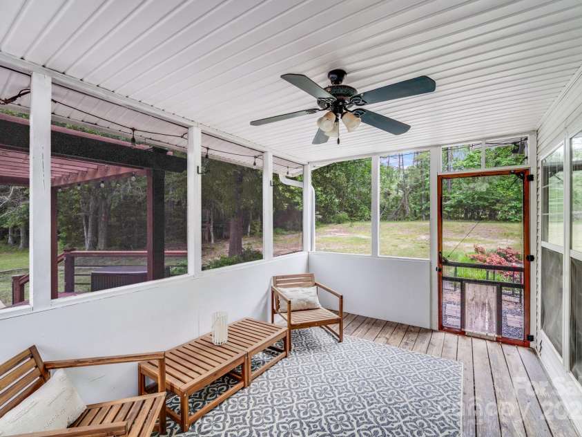 6910 Birdsong Lane, Waxhaw, NC 28173.  MLS# CAR4253788, YatesRealty ID 11745. Screened porch with low maintenance ceiling and warm wood floors - enjoy the outdoors bug-free all year long!