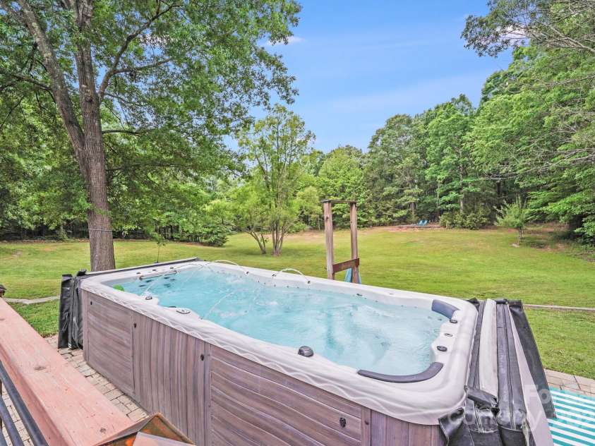 6910 Birdsong Lane, Waxhaw, NC 28173.  MLS# CAR4253788, YatesRealty ID 11745. Swim spa with jets and fountains, perfect for fitness and leisure