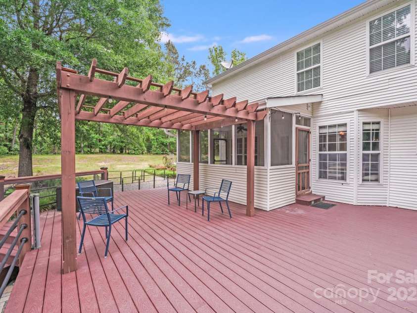 6910 Birdsong Lane, Waxhaw, NC 28173.  MLS# CAR4253788, YatesRealty ID 11745. Trex deck with lighted fence posts, and a cozy pergola— the perfect spot for sunset dinners and starry nights