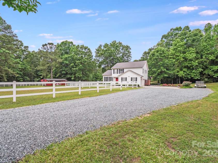 6910 Birdsong Lane, Waxhaw, NC 28173.  MLS# CAR4253788, YatesRealty ID 11745. Well constructed gravel driveway leads you home