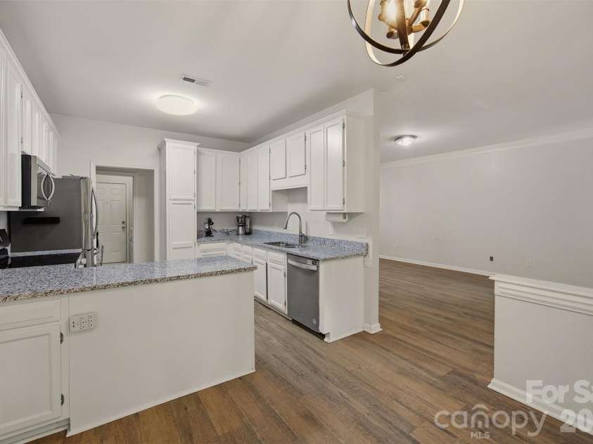 10008 Prosperity Point Lane, Charlotte, NC 28269.  MLS# CAR4362897, YatesRealty ID 11746. Kitchen and living room