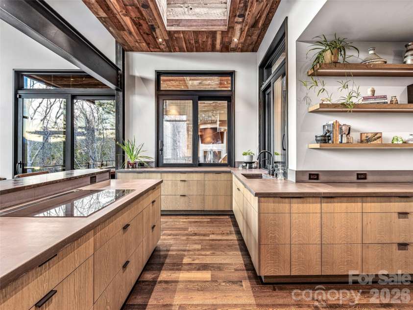 112 Moon Shadow Lane, Marshall, NC 28753.  MLS# CAR4332984, YatesRealty ID 1175. Concrete countertops, induction cooktop with downdraft and pass through window to porch with the added brightness of the skylight.