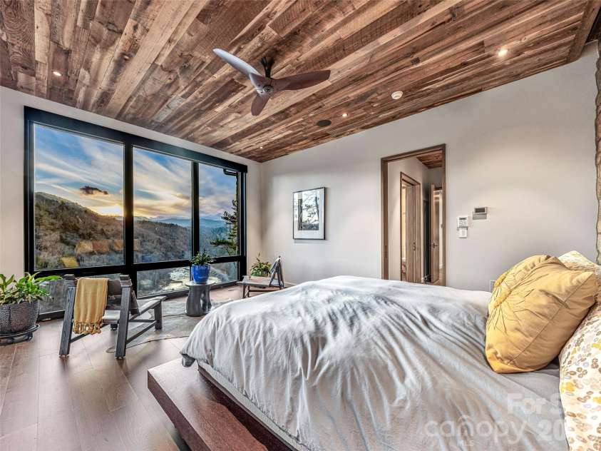 112 Moon Shadow Lane, Marshall, NC 28753.  MLS# CAR4332984, YatesRealty ID 1175. Primary suite with floor to ceiling windows with a private terrace to watch the sunsets.