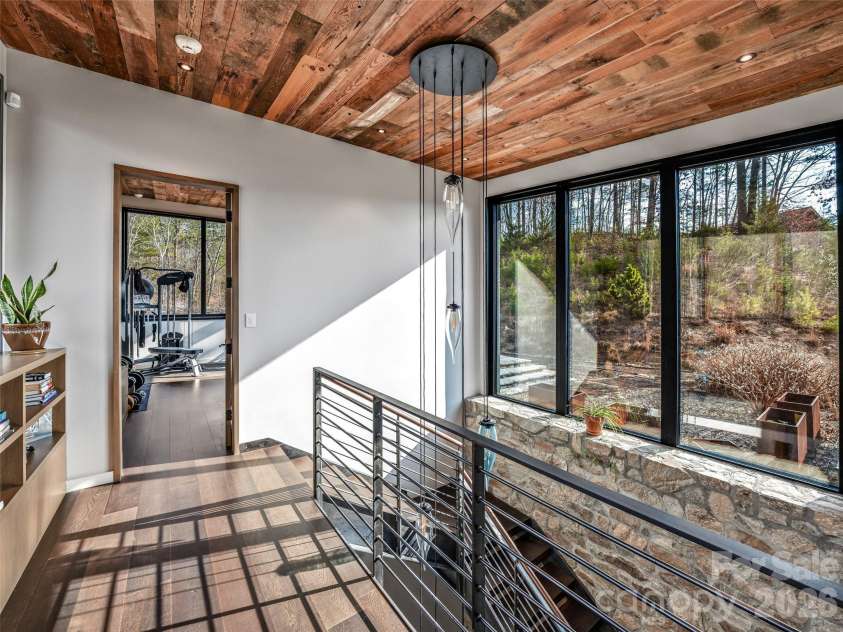 112 Moon Shadow Lane, Marshall, NC 28753.  MLS# CAR4332984, YatesRealty ID 1175. Upper level gym/flex room with full bath and opening out to a private patio.
