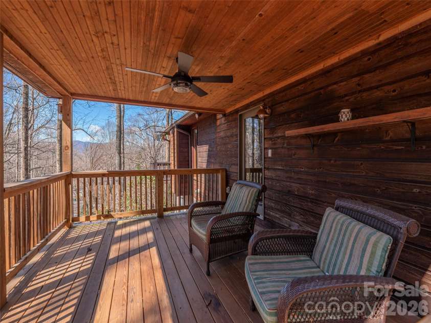 56 Southwicke Drive, Arden, NC 28704.  MLS# CAR4368299, YatesRealty ID 11771. The covered deck taking in the distant mountain views and peaceful setting