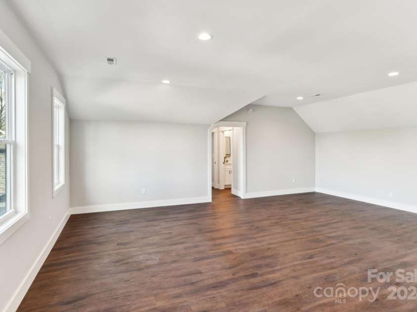 129 Oak Apple Lane, Hendersonville, NC 28792.  MLS# CAR4205968, YatesRealty ID 1178. Second leveling living room/flex space leading to a bedroom and full bathroom