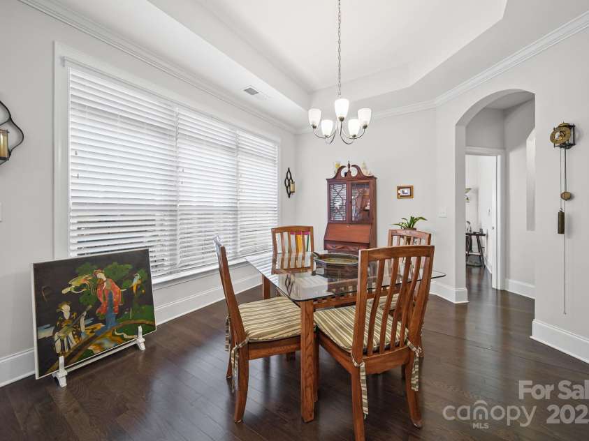 4516 Ideal Way, Harrisburg, NC 28075.  MLS# CAR4325804, YatesRealty ID 1178. The Dining Area off The Kitchen Features Beautiful Wood Floors and a View of the Patio Area.