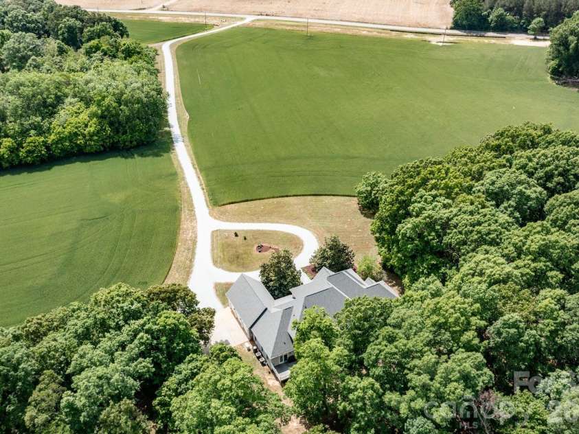 1720 Mills Harris Road, Wingate, NC 28174.  MLS# CAR4366223, YatesRealty ID 11793. Arial View House & Driveway