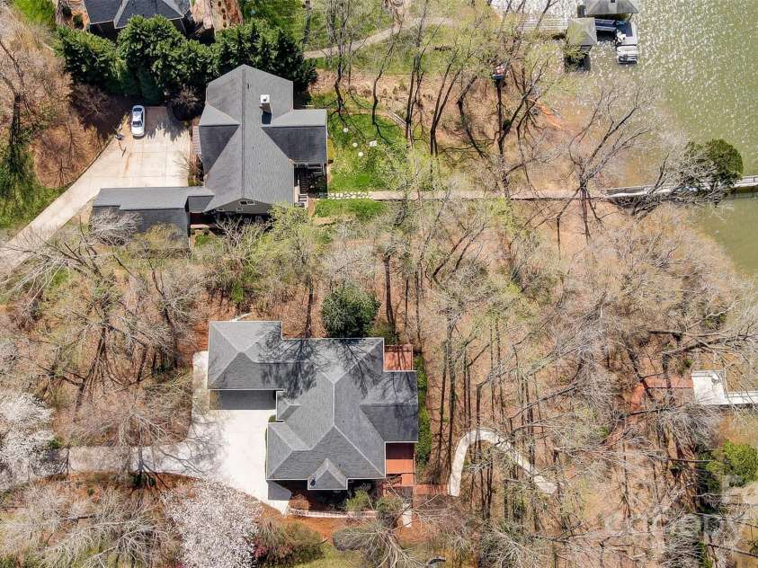 4633 River Bluff Court, Charlotte, NC 28214.  MLS# CAR4235344, YatesRealty ID 11796. Imagine entertaining friends & family in your private outdoor oasis, featuring a massive deck, covered patio, lush landscaping, lakeside deck, & covered dock w/ boat lift – the perfect launchpad for your boating adv