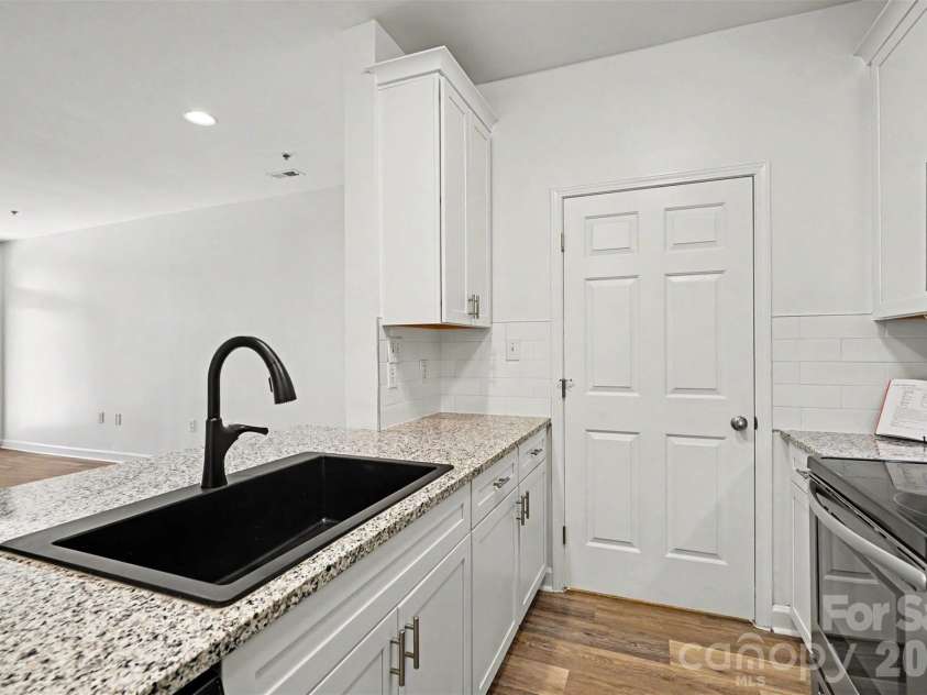 104 Pier 33 Drive, Mooresville, NC 28117.  MLS# CAR4378034, YatesRealty ID 11800. Laundry is located behind the door along with cabinets that could be a pantry.