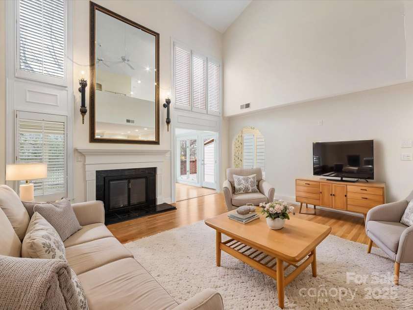 2027 Meadowood Lane, Charlotte, NC 28211.  MLS# CAR4224045, YatesRealty ID 11807. 2 Story Great Room with Fireplace and plenty of windows for natural light. (Virtually Staged)