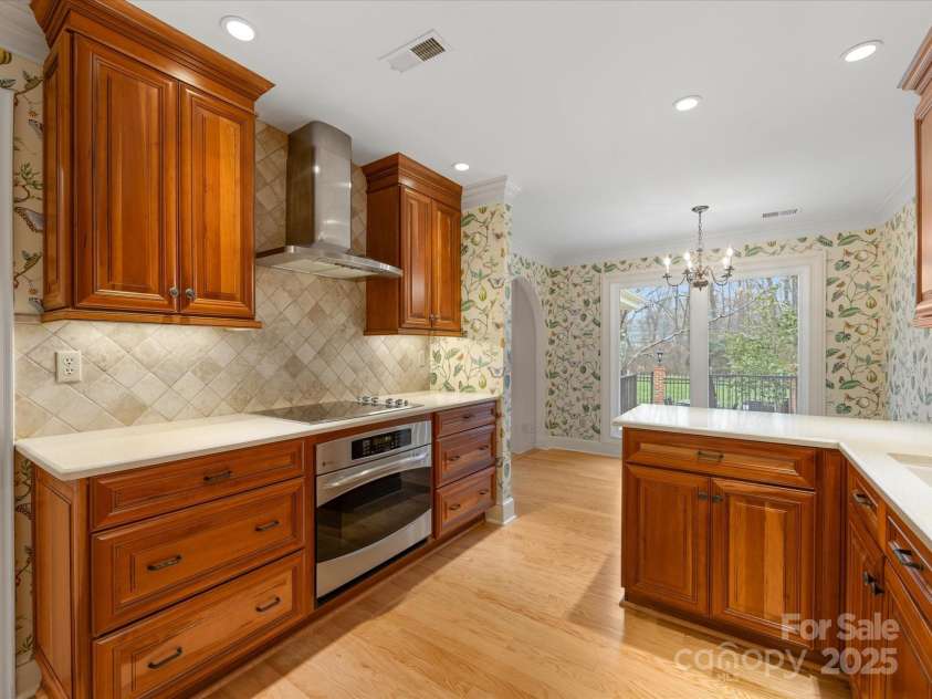 2027 Meadowood Lane, Charlotte, NC 28211.  MLS# CAR4224045, YatesRealty ID 11807. Beautiful Solid Wood Kitchen Cabinets  (new since owner purchased home) with Solid Surface Counters and Stainless Appliances.