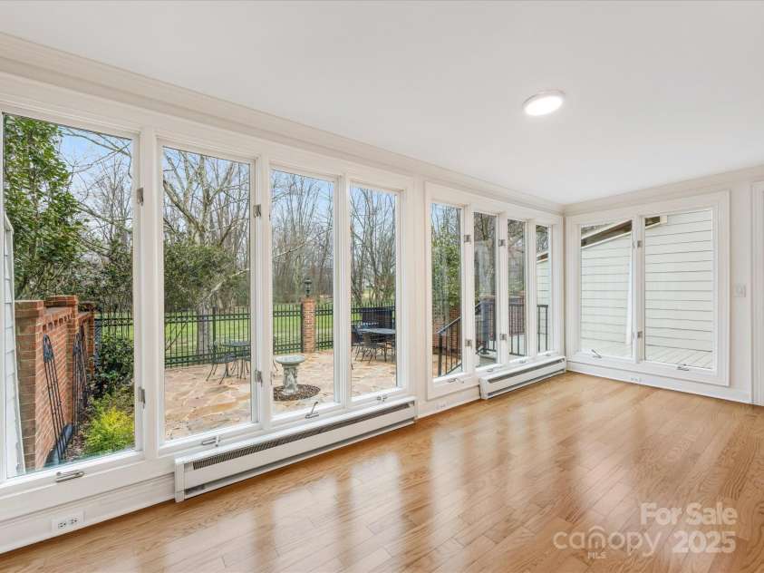 2027 Meadowood Lane, Charlotte, NC 28211.  MLS# CAR4224045, YatesRealty ID 11807. Sunroom overlooks private fenced back yard with stone patio and New Deck.