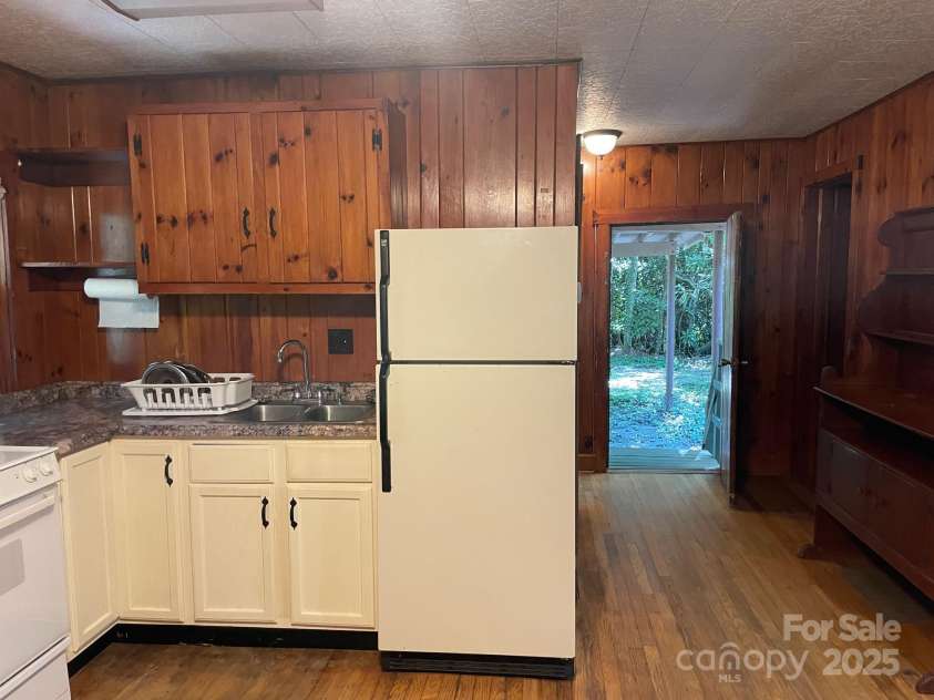142 Whitewater Road, Sapphire, NC 28774.  MLS# CAR4229231, YatesRealty ID 1185. Kitchen looking toward the back door 