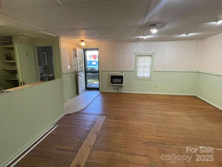 142 Whitewater Road, Sapphire, NC 28774.  MLS# CAR4229231, YatesRealty ID 1185. View of living room to front door 