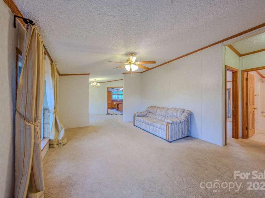 22 Hominy Baptist Church Road, Candler, NC 28715.  MLS# CAR4255118, YatesRealty ID 11853. Living Room view into dinning room and kitchen