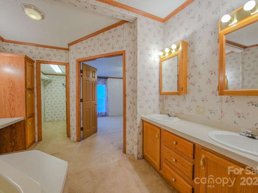22 Hominy Baptist Church Road, Candler, NC 28715.  MLS# CAR4255118, YatesRealty ID 11853. Primary Bathroom view into bedroom and large walk in closet