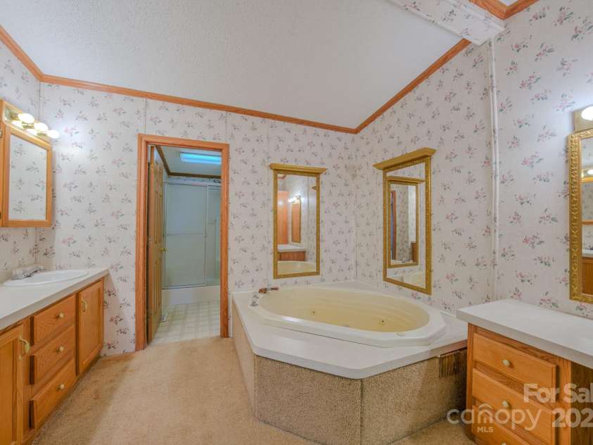 22 Hominy Baptist Church Road, Candler, NC 28715.  MLS# CAR4255118, YatesRealty ID 11853. Primary bathroom w/seperate room for shower and potty