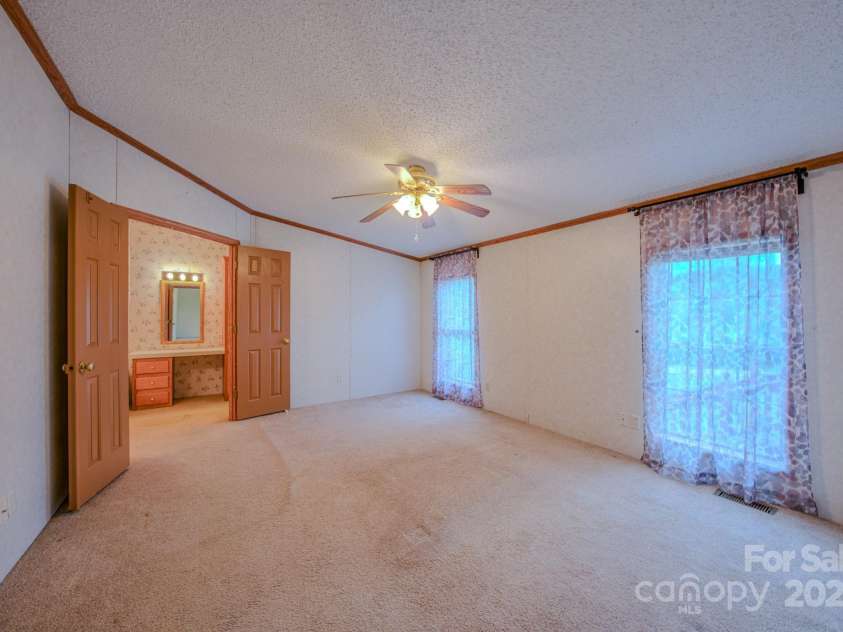 22 Hominy Baptist Church Road, Candler, NC 28715.  MLS# CAR4255118, YatesRealty ID 11853. Primary Bedroom looking into primary bathroom