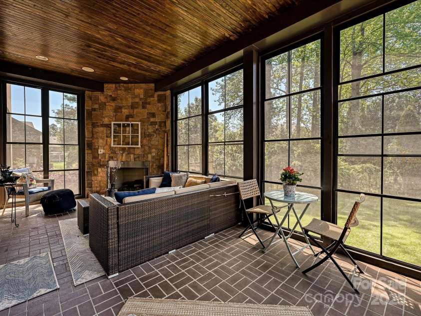 7208 Ashton Gate Drive, Charlotte, NC 28270.  MLS# CAR4246085, YatesRealty ID 11858. Three seasons Porch with Gas Fireplace - view to backyard
