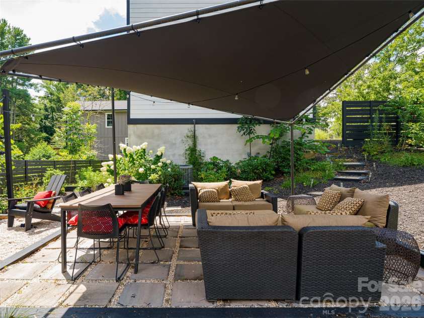 197 Chatham Road, Asheville, NC 28804.  MLS# CAR4290361, YatesRealty ID 11880. Covered outside entertainment area surrounded by raised beds and stunning landscaping
