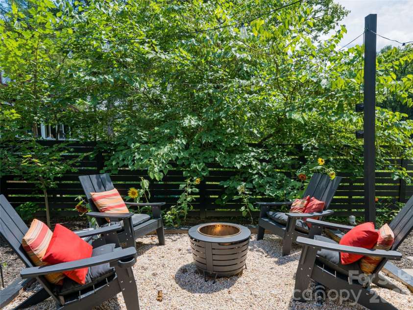 197 Chatham Road, Asheville, NC 28804.  MLS# CAR4290361, YatesRealty ID 11880. Large fire pit area in flat back yard. Privacy fence