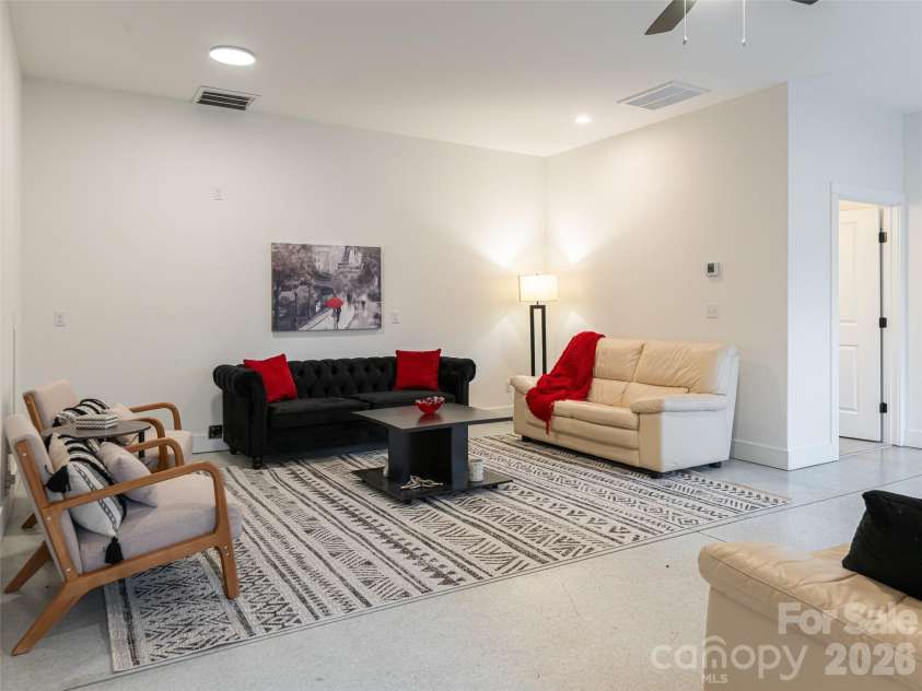 197 Chatham Road, Asheville, NC 28804.  MLS# CAR4290361, YatesRealty ID 11880. Lower Level Family room with separate entrance on lower level. With this separate entrance, this area is perfect for family members, guests, long -term rental etc. Versatile space with polished concrete flooring.