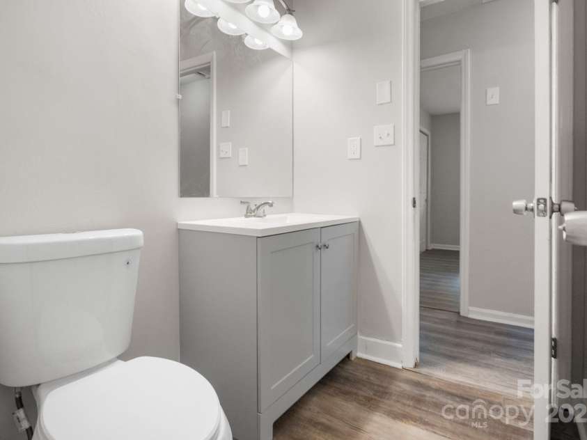 816 Echo Glen Road, Charlotte, NC 28213.  MLS# CAR4248212, YatesRealty ID 11891. Half bath, connected to full bath and to remainder of home through hallway (pictured open). Back is to door that opens to full bathroom.