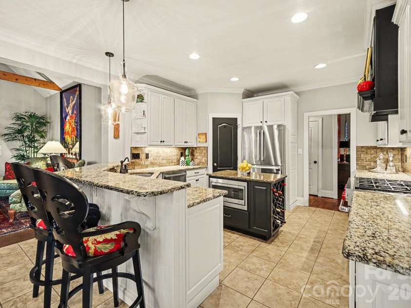 6722 Fox Ridge Circle, Davidson, NC 28036.  MLS# CAR4334663, YatesRealty ID 11905. Kitchen island with built in microwave and wine storage. 
