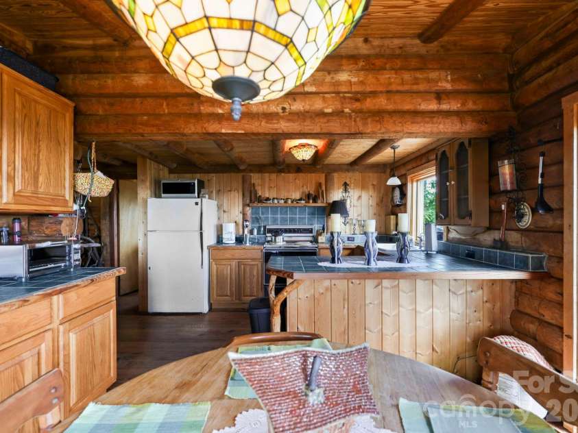 305 Stamey Creek Road, Brevard, NC 28712.  MLS# CAR4368936, YatesRealty ID 11907. Open Kitchen Dining Room