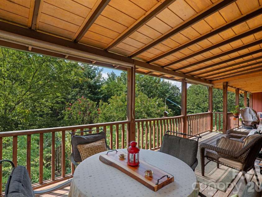 150 Avondale Ridge Road, Asheville, NC 28803.  MLS# CAR4355804, YatesRealty ID 11932. A covered back deck perched in the canopy - perfect for bird watching!