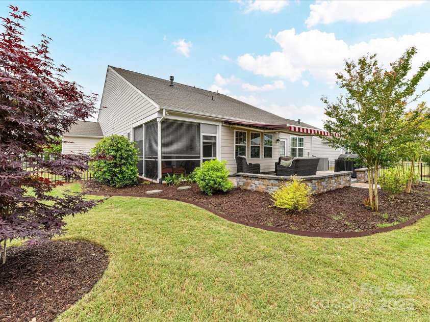 3333 Oliver Stanley Trail, Lancaster, SC 29720.  MLS# CAR4251729, YatesRealty ID 11943. Rear View shows Patio Walls. Landscape Beds