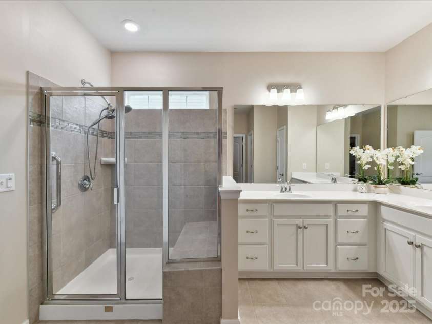 3333 Oliver Stanley Trail, Lancaster, SC 29720.  MLS# CAR4251729, YatesRealty ID 11943. Upgraded Cabinets in Primary Bath. Walk in Shower with Bench Seat