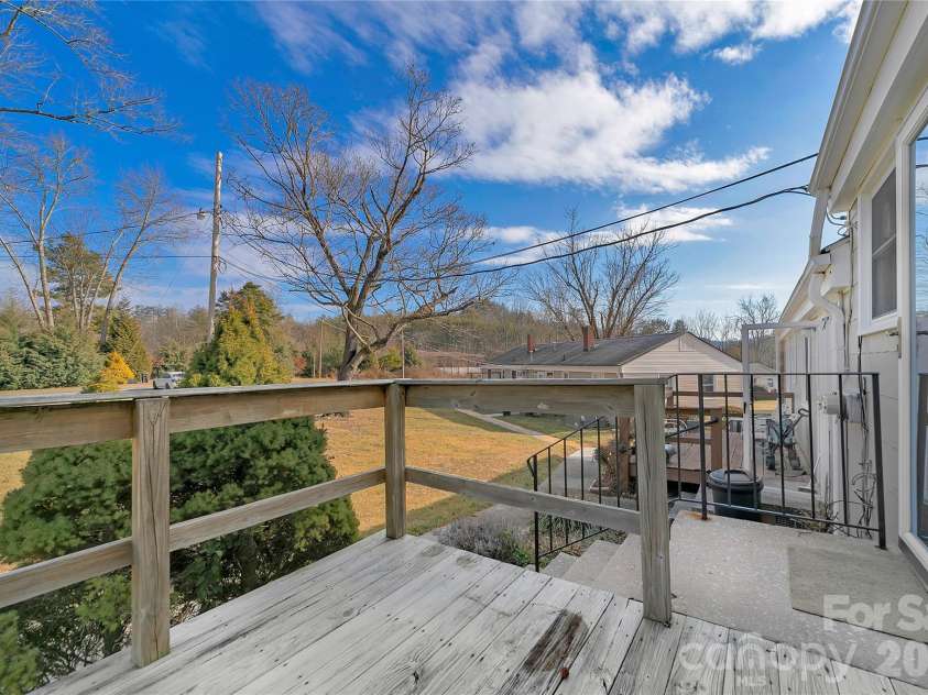 19 Trowbridge Lane, Brevard, NC 28712.  MLS# CAR4342607, YatesRealty ID 11965. Back deck overlooking common area