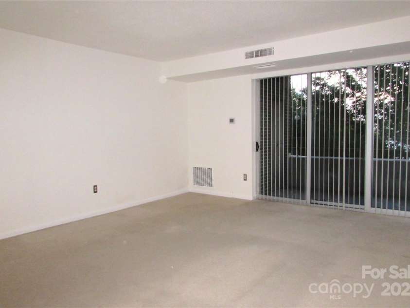 1300 Reece Road, Charlotte, NC 28209.  MLS# CAR4185948, YatesRealty ID 1200. Large LR with wide windows leading to balcony