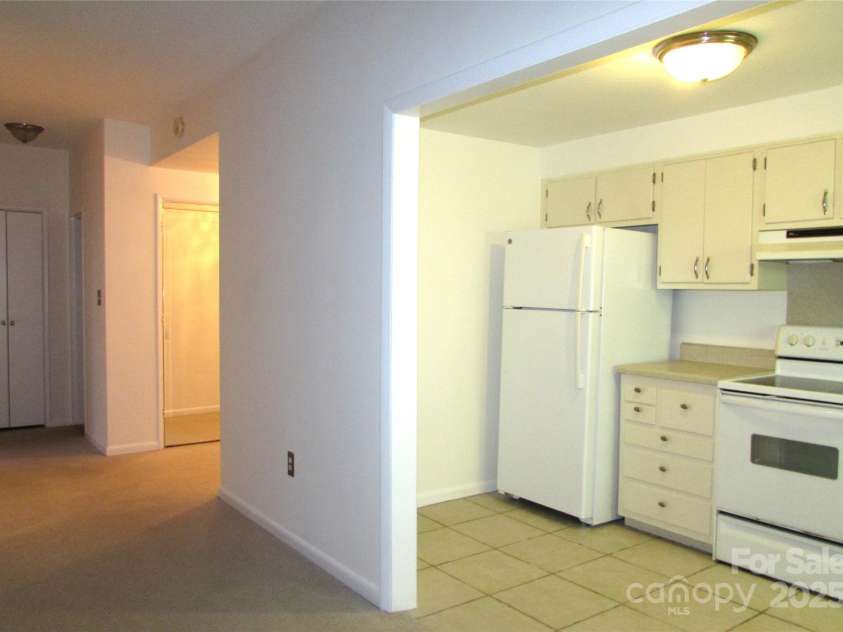 1300 Reece Road, Charlotte, NC 28209.  MLS# CAR4185948, YatesRealty ID 1200. View from LR showing kitchen and entrance/hall