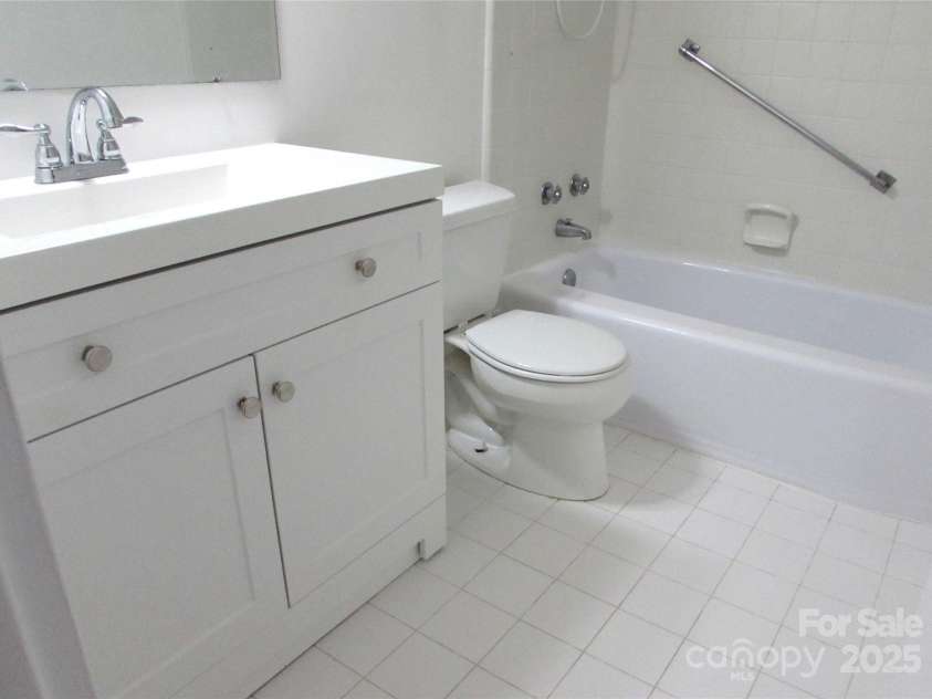 1300 Reece Road, Charlotte, NC 28209.  MLS# CAR4185948, YatesRealty ID 1200. View of bathroom showing white tile floor