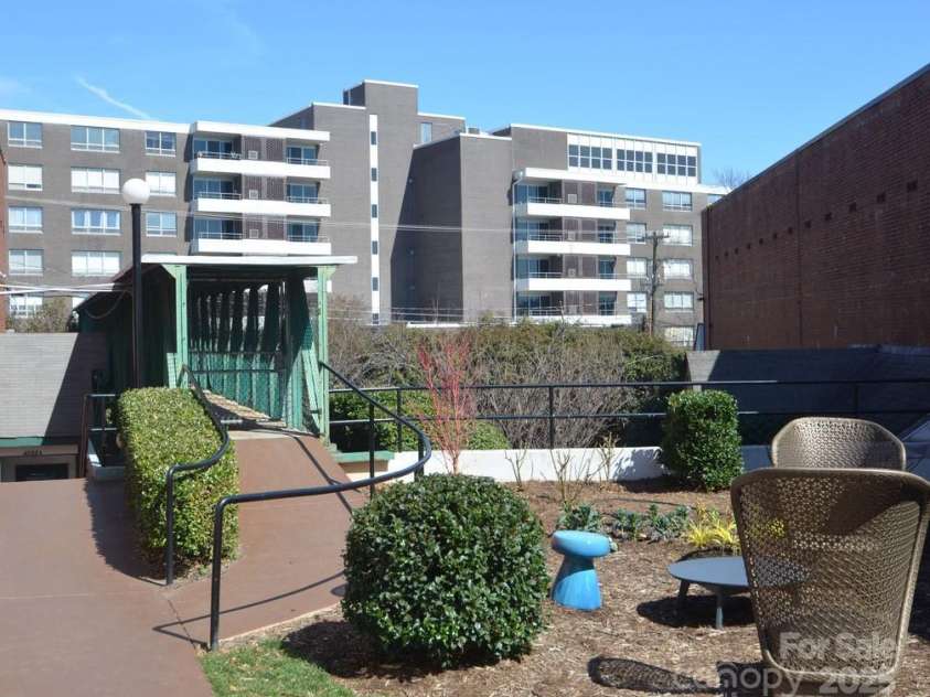 1300 Reece Road, Charlotte, NC 28209.  MLS# CAR4185948, YatesRealty ID 1200. Walkway (ramp) from The Kimberlee over to Park Rd. Shopping Ctr.