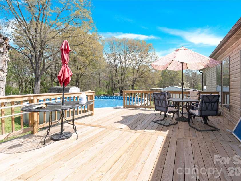3770 Macklin Street, Claremont, NC 28610.  MLS# CAR4365332, YatesRealty ID 12010. Large deck steps to pool