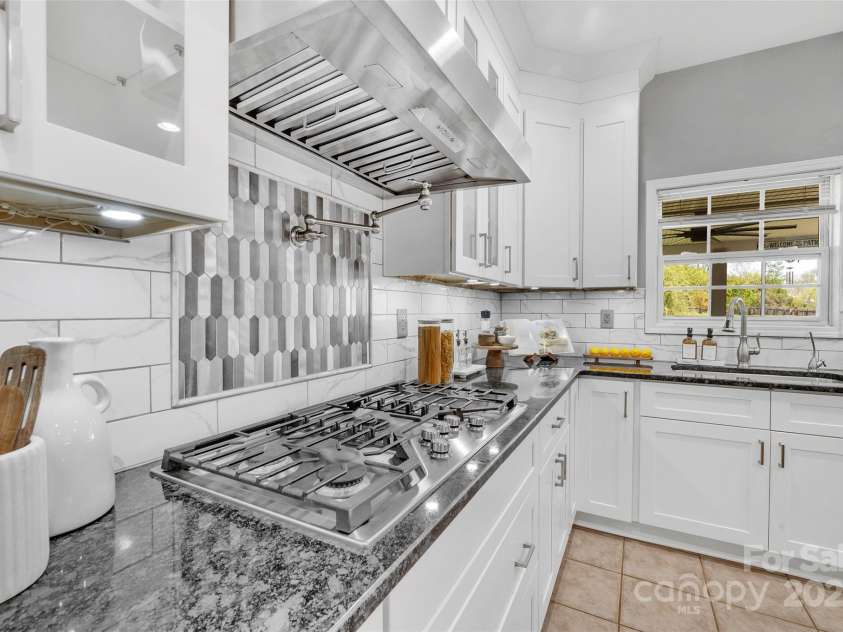 5412 Fulton Ridge Drive, Indian Trail, NC 28079.  MLS# CAR4237895, YatesRealty ID 12017. Note the attention to detail like this gas stove and conveniently located pot filler making this kitchen a joy to cook in.