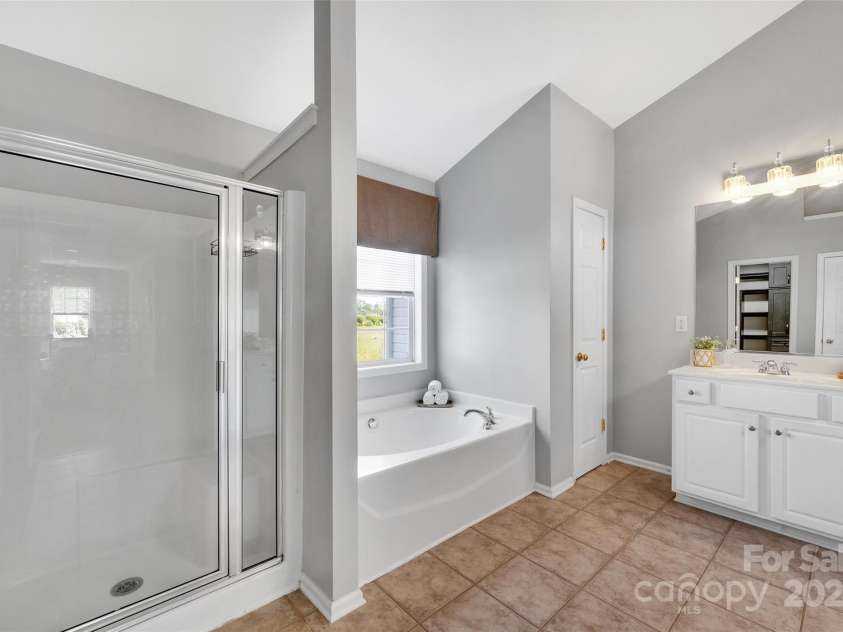 5412 Fulton Ridge Drive, Indian Trail, NC 28079.  MLS# CAR4237895, YatesRealty ID 12017. Primary suite has separate step in shower and garden tub.