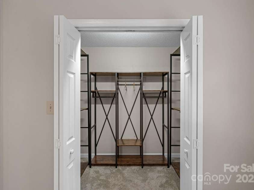 2730 Tiffany Drive, Rock Hill, SC 29732.  MLS# CAR4327115, YatesRealty ID 12020. Walk-in closet off of the primary bedroom with custom built-in shelving.