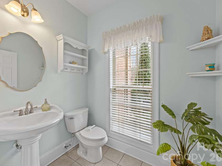 7717 Cottonwood Drive, Denver, NC 28037.  MLS# CAR4352236, YatesRealty ID 12034. Main level half bath, tucked away from living areas