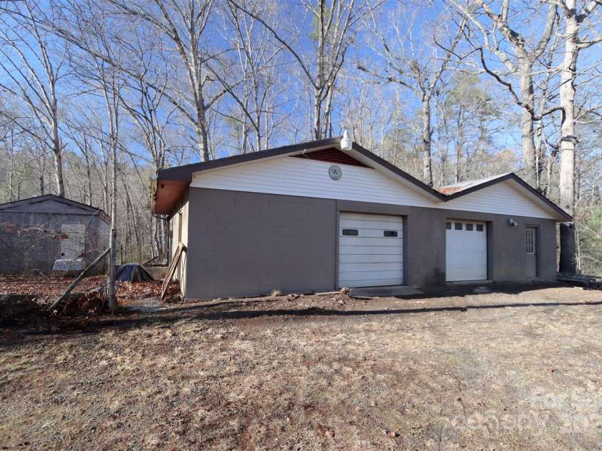 388 Island Creek Road, Lake Lure, NC 28746.  MLS# CAR4062749, YatesRealty ID 1204. 2-car garage with storage and workshop