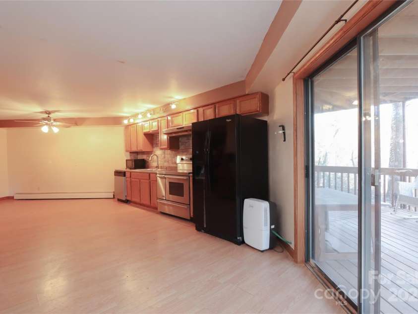388 Island Creek Road, Lake Lure, NC 28746.  MLS# CAR4062749, YatesRealty ID 1204. Lower level kitchen with sliders to covered deck