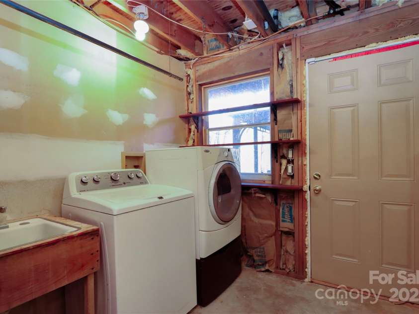 388 Island Creek Road, Lake Lure, NC 28746.  MLS# CAR4062749, YatesRealty ID 1204. Lower level laundry and door to deck