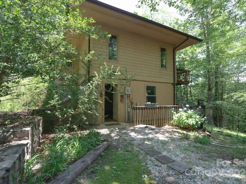 388 Island Creek Road, Lake Lure, NC 28746.  MLS# CAR4062749, YatesRealty ID 1204. Side of main home from drive