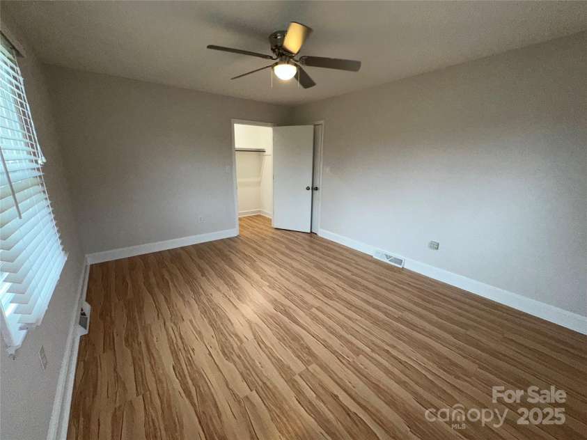 396 Pitts School Road, Concord, NC 28027.  MLS# CAR4251214, YatesRealty ID 12047. Inside bedroom #2 + ceiling fan & nice closet with light